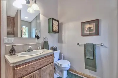 a bathroom with a sink and a toilet and a mirror at 2272L The Lupine Lodge in South Lake Tahoe