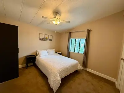 a bedroom with a bed and a ceiling fan at Scenic Lake House & Dog Friendly in Wofford Heights