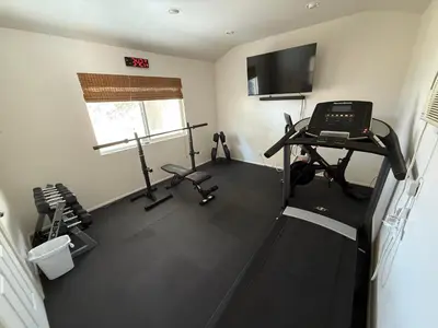 an overhead view of a gym with tread machines and a television at Scenic Lake House & Dog Friendly in Wofford Heights