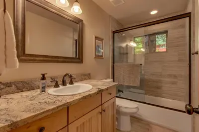 a bathroom with a sink and a toilet and a mirror at The Westlands Lodge 1135AC in South Lake Tahoe