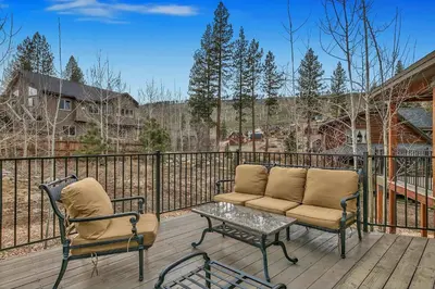 a patio with two chairs and a coffee table on a deck at 1044C Coyote Ridge in South Lake Tahoe