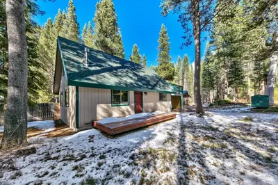 a small house in the woods in the snow at 1207S Cabin in the Pines in South Lake Tahoe