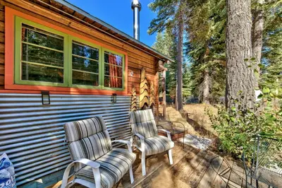 two chairs sitting on the porch of a cabin at 1577A The Tahoe Lazy Bear in South Lake Tahoe