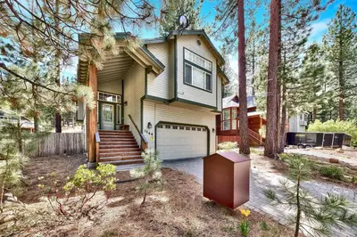 a small house with a garage in the woods at 1144GB The Golden Bear Retreat in South Lake Tahoe