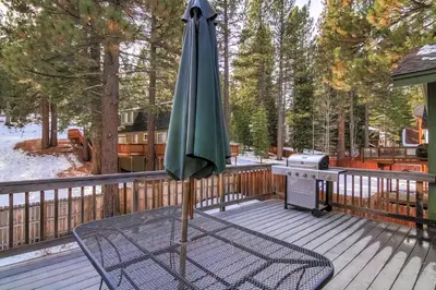 an umbrella sitting on a deck with a grill at 1144GB The Golden Bear Retreat in South Lake Tahoe