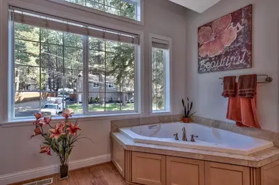 a bathroom with a large tub and a window at 122G Where Eagles Fly in South Lake Tahoe