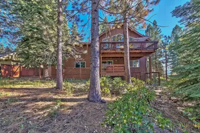 a log home with a deck in the woods at 122G Where Eagles Fly in South Lake Tahoe