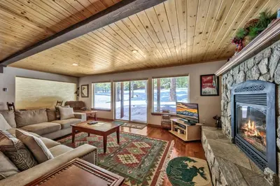 a living room with a couch and a fireplace at Tall Pines in South Lake Tahoe