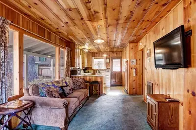 a living room with a couch and a flat screen tv at 3993C Cedar Cabin Lake Tahoe in South Lake Tahoe