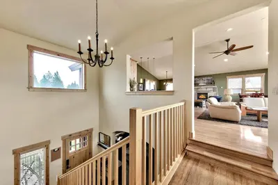 a living room with a staircase and a chandelier at 1376MD Angora View in South Lake Tahoe