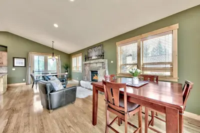 a living room with a table and a fireplace at 1376MD Angora View in South Lake Tahoe