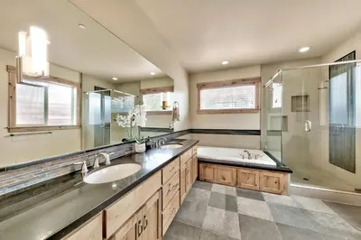 a bathroom with two sinks and a shower and a tub at 1376MD Angora View in South Lake Tahoe