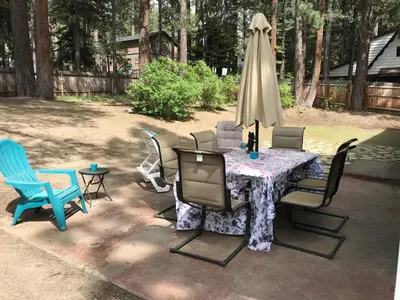a table with chairs and an umbrella in a yard at Peace of Heaven 2566C in South Lake Tahoe