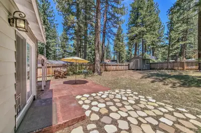 a patio with an umbrella next to a fence at Peace of Heaven 2566C in South Lake Tahoe