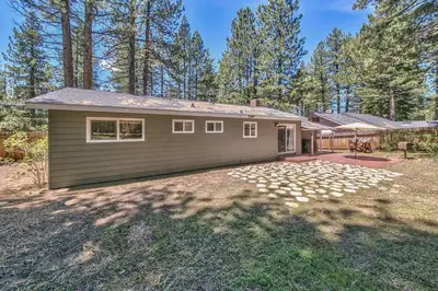 a small house with a garage in a yard at Peace of Heaven 2566C in South Lake Tahoe