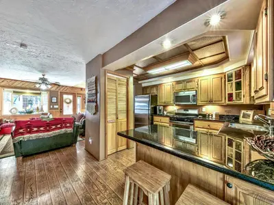 a kitchen and a living room with a couch at 2556H Lazy Bear's Den in South Lake Tahoe