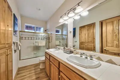a bathroom with two sinks and a large mirror at 1213GB Golden Bear Tahoe Home in South Lake Tahoe