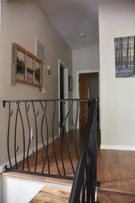 a staircase in a house with a black railing at 2375S Sierra house Retreat in South Lake Tahoe