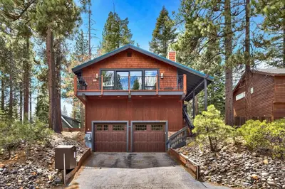a house in the woods with a balcony at 2375S Sierra house Retreat in South Lake Tahoe