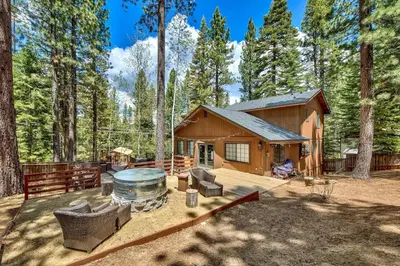 a log cabin in the woods with a grill at 1760T Thunderbird Cabin in South Lake Tahoe