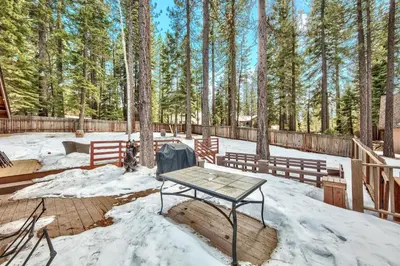 a picnic table in the snow on a deck at 1760T Thunderbird Cabin in South Lake Tahoe