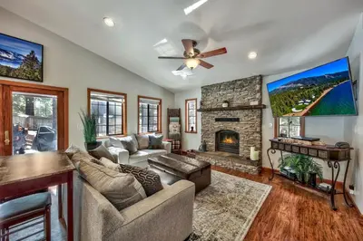 a living room with a couch and a fireplace at 1760T Thunderbird Cabin in South Lake Tahoe