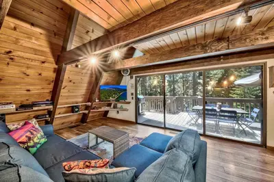 a living room with a blue couch in a house at 3001R Reindeer A Frame Cabin in South Lake Tahoe