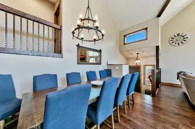 a dining room with a table and blue chairs at Mountain View Retreat 1008C in South Lake Tahoe