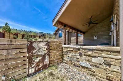 a house with a wooden fence next to a building at Mountain View Retreat 1008C in South Lake Tahoe