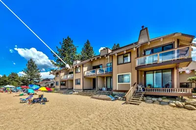 a building on a beach with people on the sand at 920 Bal Bijou in South Lake Tahoe
