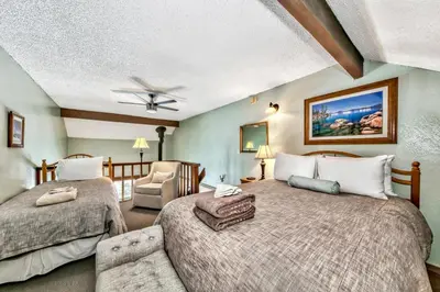 a bedroom with two beds and a living room at 920 Bal Bijou in South Lake Tahoe