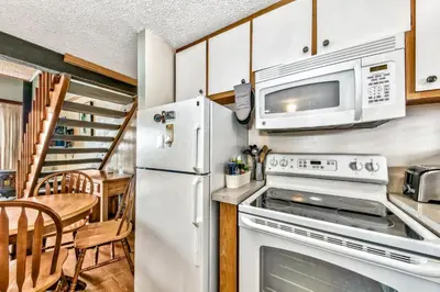 a kitchen with a white refrigerator and a microwave at 920 Bal Bijou in South Lake Tahoe