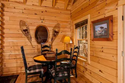 a dining room with a table and chairs in a cabin at Tahoe Moose Lodge 1170AC in South Lake Tahoe