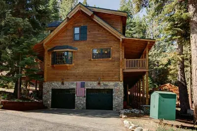 a large wooden house with a large garage at Tahoe Moose Lodge 1170AC in South Lake Tahoe