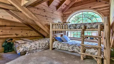 a bedroom with two bunk beds in a log cabin at Tahoe Moose Lodge 1170AC in South Lake Tahoe