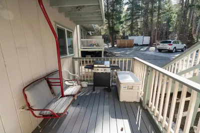 a porch with a bench and a grill on a house at RR-Birch_Creek 2 in June Lake