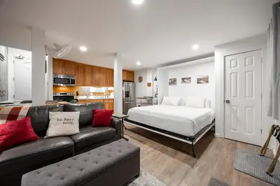 a living room with a couch and a bed at Stunning Deluxe King Studio #124 at Donner Lake Village in Truckee