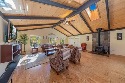 a living room with a couch and a table at Yosemite Wooded Hills, Pool Table, Fitness, Views in Oakhurst