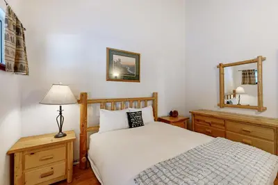 a bedroom with a bed and a mirror at Less Than 2 Mi to Tahoe Donner Ski Resort Serene Retreat in Armstrong