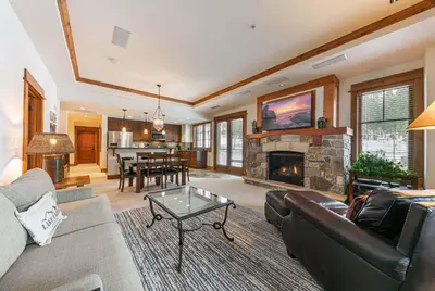 a living room with a couch and a fireplace at Big Horn Lodge 202 by East West Hospitality in Truckee