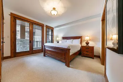 a bedroom with a bed and a large window at Big Horn Lodge 202 by East West Hospitality in Truckee