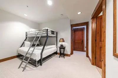 a bedroom with a bunk bed with a ladder at Big Horn Lodge 202 by East West Hospitality in Truckee