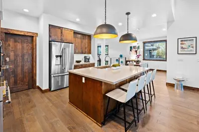 a kitchen with a large island with white counter tops at Luxurious Truckee Rental Hot Tub and Valley Views in Truckee