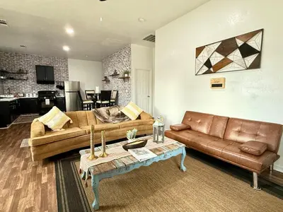 a living room with two couches and a table at GUEST RANCH HOUSE w POOL access near NATL PARKS in Dinuba