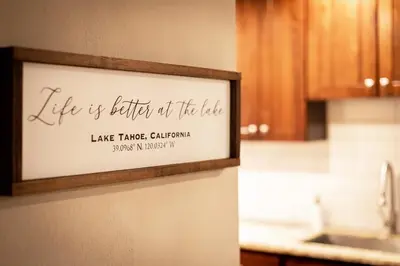 a sign that reads life is better at the lodge at Miztec Mountain - Ping pong & basketball hoop game in South Lake Tahoe