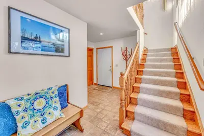 a staircase in a home with a tv on the wall at Spacious Tahoe City Home with Foosball and Lake Views in Tahoe City