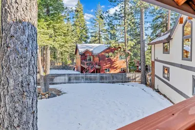a log cabin in the woods with snow on the ground at Spacious Tahoe City Home with Foosball and Lake Views in Tahoe City
