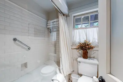 a white bathroom with a toilet and a shower at Lakefront Luxury in Tahoe City