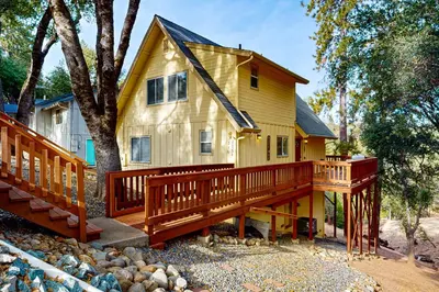 a home with a large deck and a house at Serendipity in Groveland