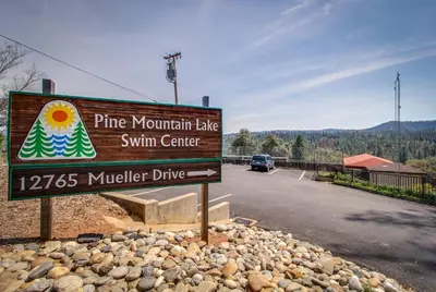 a sign for a pine mountain lake swim center on a road at Serendipity in Groveland